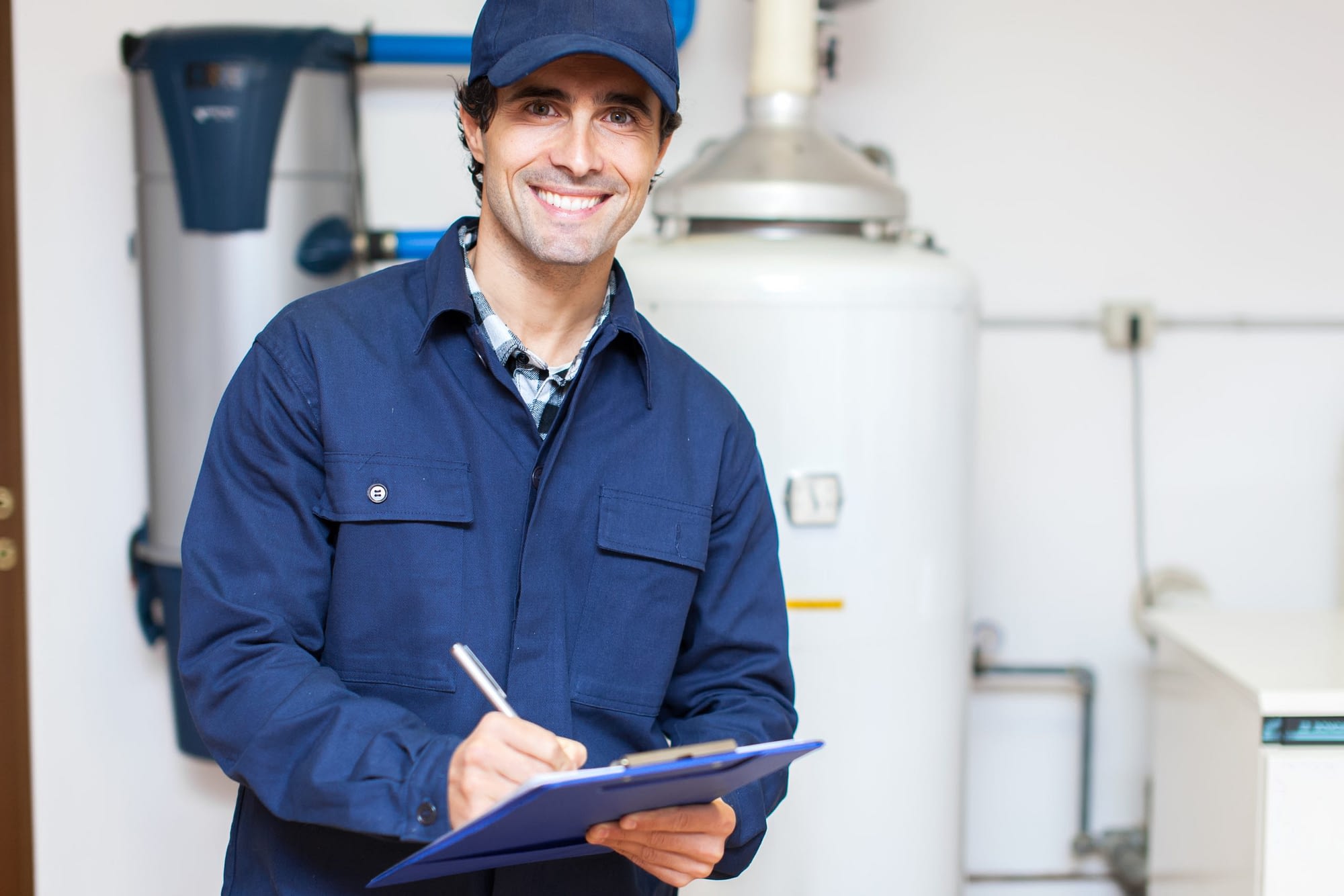 Smiling water heater expert performing inspection